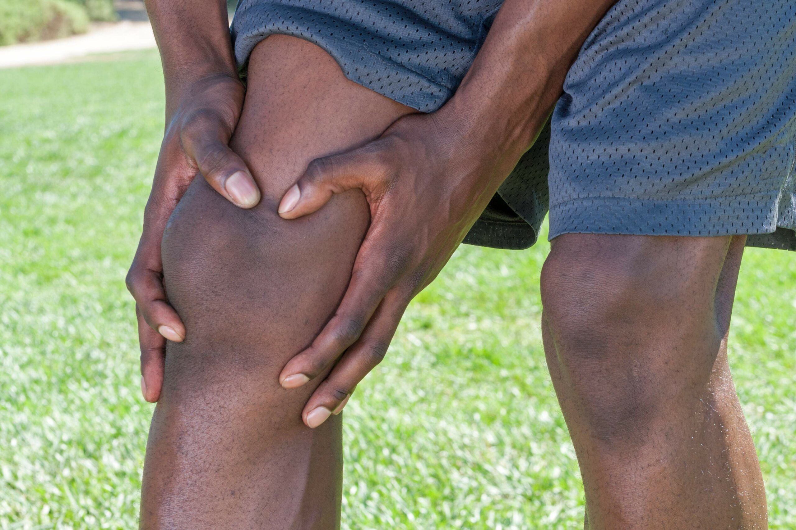 Athlete Inspecting Knee Pain