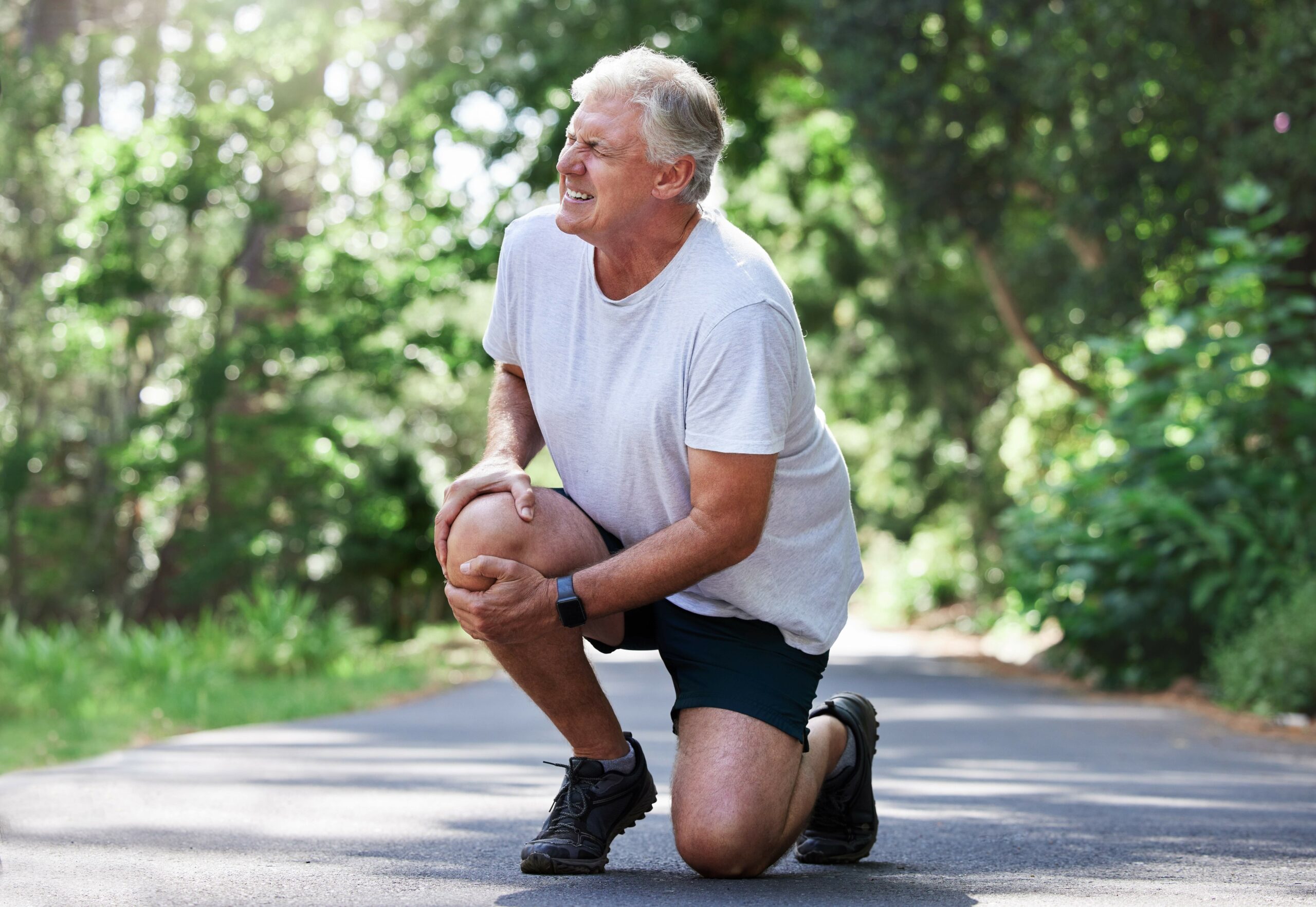 Older Man Grabbing Knee in Pain